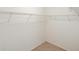 Walk-in closet featuring carpet flooring and white metal shelving at 25929 Newcombe Cir, Leesburg, FL 34748