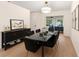 This dining room includes wood floors, a modern light fixture, and seating for six at 25929 Newcombe Cir, Leesburg, FL 34748
