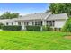Charming single-story home featuring a lush green lawn and mature landscaping at 25929 Newcombe Cir, Leesburg, FL 34748