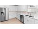 Kitchen with stainless steel appliances, white cabinets, and ample counter space at 25929 Newcombe Cir, Leesburg, FL 34748
