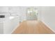 Open-concept living space with light wood floors and glass doors to a patio at 25929 Newcombe Cir, Leesburg, FL 34748