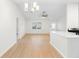 Open-concept living space with modern lighting, sleek flooring, and a view into the kitchen at 25929 Newcombe Cir, Leesburg, FL 34748