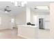 Bright living room with modern lighting, stainless steel appliances, and an open layout at 25929 Newcombe Cir, Leesburg, FL 34748