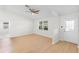 Bright living room with light wood floors, a ceiling fan, and a front door at 25929 Newcombe Cir, Leesburg, FL 34748