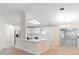 Open-concept kitchen and dining area featuring ample natural light and neutral decor at 25929 Newcombe Cir, Leesburg, FL 34748