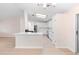 Bright, open-concept space with a modern kitchen featuring white cabinets and stainless steel appliances at 25929 Newcombe Cir, Leesburg, FL 34748
