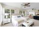 Large main bedroom boasts multiple windows, ceiling fan, and calming color palette at 25929 Newcombe Cir, Leesburg, FL 34748