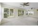 Light-filled sunroom with wall to wall windows offering serene outdoor views at 25929 Newcombe Cir, Leesburg, FL 34748