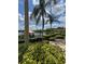 Scenic view of the lake with a gazebo, lush landscaping, and palm trees with a partially cloudy sky overhead at 3045 Yellow Lantana Ln, Kissimmee, FL 34747