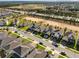 An aerial view showcasing the neighborhood, surrounding streets, and nearby open spaces at 669 Big Pine Ave, Minneola, FL 34715