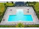Aerial shot featuring the rectangular community pool with lounge chairs and shaded seating areas at 669 Big Pine Ave, Minneola, FL 34715
