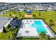 Aerial view of the community pool, clubhouse, playground, and surrounding homes in the neighborhood at 669 Big Pine Ave, Minneola, FL 34715