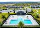 Aerial view of the community pool and clubhouse including ample lounge chairs and shaded tables at 669 Big Pine Ave, Minneola, FL 34715