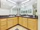 Spacious bathroom featuring double sinks, granite countertops, and plenty of cabinet space at 9051 Treasure Trove Ln # 405, Kissimmee, FL 34747