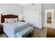 Comfortable main bedroom with neutral decor, a plush bed, and a view of the en-suite bathroom at 9051 Treasure Trove Ln # 405, Kissimmee, FL 34747