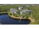 Beautiful aerial view of lakeside condos with lush landscaping and tranquil surroundings at 9061 Treasure Trove Ln # 104, Kissimmee, FL 34747