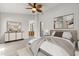 Spacious main bedroom with ceiling fan, artwork, and entry to an attached bathroom at 503 Moree Loop, Winter Springs, FL 32708