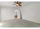 Bedroom featuring ceiling fan, new carpet, and access to the bathroom at 503 Moree Loop, Winter Springs, FL 32708