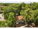 Aerial view of a two-story home surrounded by lush green trees and landscaping at 503 Moree Loop, Winter Springs, FL 32708