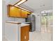 Bright kitchen featuring stainless steel refrigerator and light wood cabinetry at 503 Moree Loop, Winter Springs, FL 32708