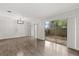 Open living room featuring sliding glass doors, modern chandelier, and wood floors at 503 Moree Loop, Winter Springs, FL 32708