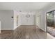 Open living room with wood floors, modern lighting, and sliding door to patio at 503 Moree Loop, Winter Springs, FL 32708