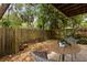 Cozy outdoor patio surrounded by a lush, green, fenced yard and mature trees at 503 Moree Loop, Winter Springs, FL 32708
