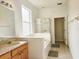 Bright bathroom with a tub and shower combo, tiled floors, and wood vanity with sink at 5421 Watervista Dr, Orlando, FL 32821