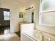 Well-lit primary bathroom with a soaking tub, a tiled vanity, and a walk-in closet at 5421 Watervista Dr, Orlando, FL 32821