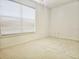 Bright, carpeted bedroom with a large window letting in plenty of natural light at 5421 Watervista Dr, Orlando, FL 32821