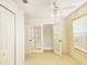 Bright bedroom with french doors to a balcony, a ceiling fan, and closet at 5421 Watervista Dr, Orlando, FL 32821