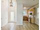An open kitchen and entry boast bright lighting and tiled floors with views of the stainless steel appliances at 5421 Watervista Dr, Orlando, FL 32821