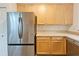 The kitchen features light wood cabinets, laminate countertops, stainless steel refrigerator, and a dishwasher at 5421 Watervista Dr, Orlando, FL 32821