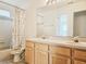 A double sink vanity is the highlight of this bathroom with a shower-tub combo at 5421 Watervista Dr, Orlando, FL 32821