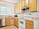 Well-lit kitchen featuring light wood cabinets, laminate countertops, stainless steel appliances, and a window view at 5421 Watervista Dr, Orlando, FL 32821
