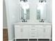 Bathroom featuring dual sinks, marble countertop and updated light fixtures at 7584 Lodge Pole Trl, Winter Park, FL 32792