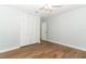 Cozy bedroom with hardwood floors, a ceiling fan, and ample closet space at 7584 Lodge Pole Trl, Winter Park, FL 32792