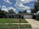 Lovely single-story home featuring a well-kept lawn and an attached garage at 7584 Lodge Pole Trl, Winter Park, FL 32792