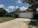 Charming single-story home with a well-maintained front yard and attached garage at 7584 Lodge Pole Trl, Winter Park, FL 32792