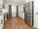 Open-concept kitchen with stainless steel appliances and wood-look flooring at 7584 Lodge Pole Trl, Winter Park, FL 32792