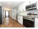 Updated kitchen featuring stainless steel appliances and modern white cabinetry at 7584 Lodge Pole Trl, Winter Park, FL 32792