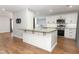 Bright kitchen with white cabinets, stainless appliances, and a large island at 7584 Lodge Pole Trl, Winter Park, FL 32792