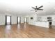 Open concept living space with hardwood floors and a modern kitchen view at 7584 Lodge Pole Trl, Winter Park, FL 32792