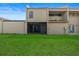 Backyard featuring a large green space and a screened patio at 106 Madrid Dr, Casselberry, FL 32707