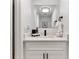 Modern powder room with sleek vanity, black hardware, and decorative mirror at 106 Madrid Dr, Casselberry, FL 32707