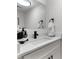 Bathroom featuring white vanity with modern faucet, and a decorative mirror at 106 Madrid Dr, Casselberry, FL 32707