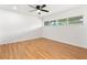 Bedroom features laminate flooring, a window providing natural light and a ceiling fan at 106 Madrid Dr, Casselberry, FL 32707