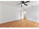 Bedroom features laminate flooring, ceiling fan, and a door with access to another room at 106 Madrid Dr, Casselberry, FL 32707