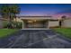 Carport with driveway featuring lush landscaping and vibrant twilight skies at 106 Madrid Dr, Casselberry, FL 32707