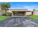Open carport with asphalt driveway, room for 2 cars and a cozy garden at 106 Madrid Dr, Casselberry, FL 32707